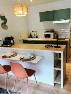 a kitchen with a table and two chairs at Studio 14 Un véritable cocon en Centre Ville in Bagnères-de-Bigorre