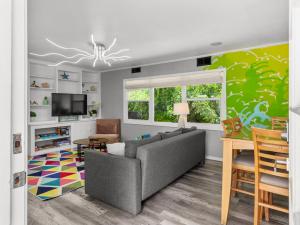 a living room with a couch and a table at Trendy & Relaxing - Close to Beach - Pool - Hot Tub in Sarasota
