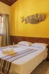 a bedroom with a bed with a fish on the wall at POUSADA ELOHIM DE BUZIOS in Búzios