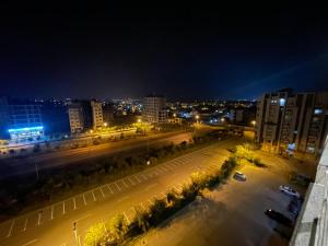 a city at night with a street and buildings at The Greystone Luxe in Rawalpindi