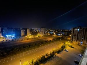 a city street at night with buildings and street lights at The Greystone Luxe in Rawalpindi