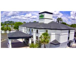 a large white building with a clock tower on top at Wingate by Wyndham Kings Bay Naval Base I-95 in Kingsland