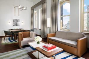 a living room with a couch and a table at The Joule Dallas in Dallas