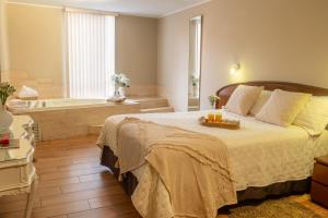 a bedroom with a bed and a bath tub at Hotel Park Suites Lima, Barranco in Lima