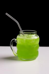 a glass jar of green liquid with a spoon in it at pyramids heaven inn in Giza +18 photos