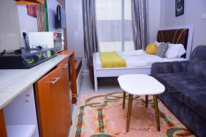 a small room with a couch and a bed at 10 minutes to Karura forest Studios in thindigua Kiambu in Nairobi +12 photos