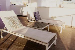 2 sedie e un divano in una stanza di Apartamentos Sol & Ria a Olhão 1 altra foto