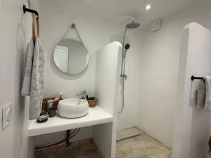 a white bathroom with a sink and a mirror at Le Clos des Pigières le Gîte de la Pierre a eau in Vaison-la-Romaine +51 photos