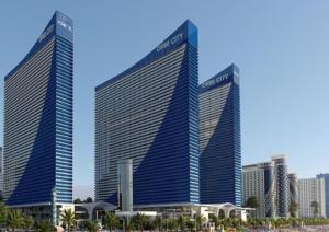 two tall buildings in front of a city at Nice Sea View Aparthotel In Orbi City Batumi in Batumi
