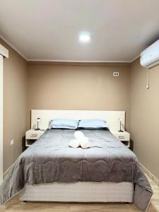 a bedroom with a bed with two towels on it at Hotel SMA in Puerto Iguazú