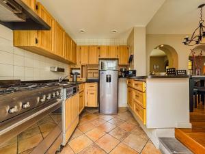 a kitchen with wooden cabinets and a stainless steel refrigerator at Departament en Polanco, CiudadDeMéxico in Mexico City