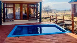 a swimming pool on a deck next to a house at Furaha Luxury Lodge in Mto wa Mbu +25 photos