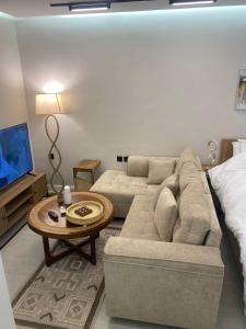a living room with a couch and a coffee table at سندباد in Riyadh +9 photos