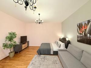 a living room with a bed and a couch at Apartment near Meidling in Vienna