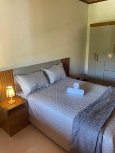 a bedroom with a bed with a teddy bear on it at Aconchego da Serra in Nova Friburgo