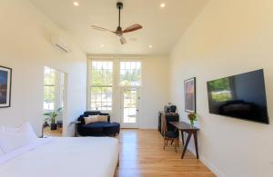 a bedroom with a bed and a tv on a wall at The Historic Schoolhouse Inn in Trinidad