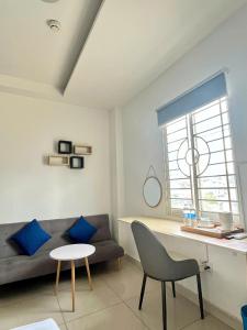 a living room with a couch and a table at Dreamie Trip and Travel Home in Ho Chi Minh City