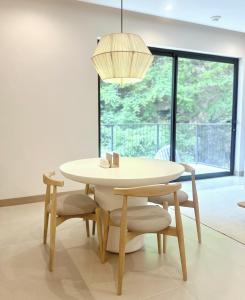 a dining room table and chairs with a large window at Brisa del Valle at Naumi, Ocean Views & Beach Club in Coco