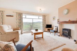 a living room with a couch and a fireplace at Mitchaven in Rothbury