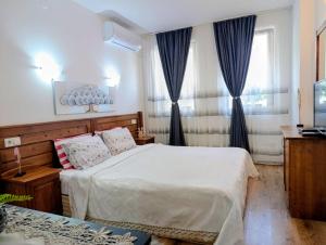 a bedroom with a large bed with blue curtains at Diamond Heights apartament in Bansko +49 photos