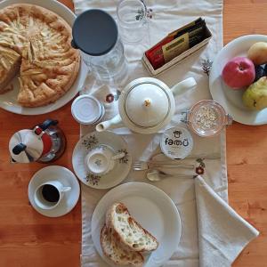 a table with plates of food and coffee and bread at B&B La RU in Montemagno +20 photos