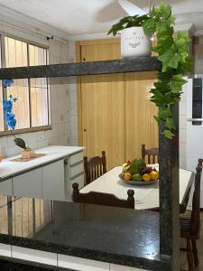 a kitchen with a table with a bowl of fruit on it at Casa MISMA in Sao Paulo