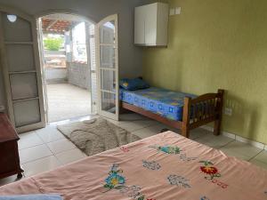 a bedroom with a bed and an open door at Casa MISMA in Sao Paulo
