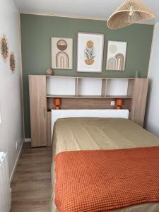 a bedroom with a bed and pictures on the wall at Fully equipped one-bedroom apartment, unpack your bags in Montreuil-Bellay