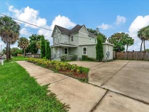 a white house with a fence and a driveway at Walking Distance to Downtown Free Parking in Tampa