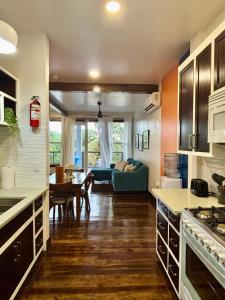 a kitchen and living room with a couch and a table at 360 Suites - Sea View, One Bedroom in Caye Caulker