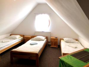 a room with two beds and a window at Noclegi Hrubieszów in Hrubieszów