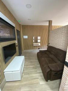 a living room with a couch and a coffee table at Apartamento en Sevilla in Seville