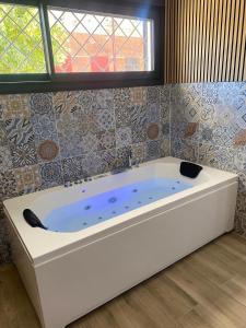 a bath tub in a room with a window at Apartamento en Sevilla in Seville +5 photos