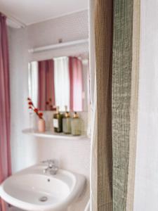 a bathroom with a sink and a mirror at Hotel Restaurant Ratsstube in Calw +29 photos