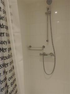 a shower in a bathroom with a shower curtain at Sea & Dunes in Scheveningen