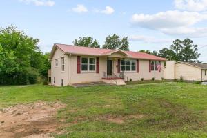 a house with a red roof on a yard at Dugan Ave Unit B in Owenton