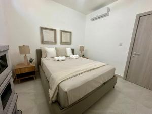 a bedroom with a bed with two towels on it at Peaceful 2BR Poolside Retreat - Punta Cana Getaway in Punta Cana +26 photos