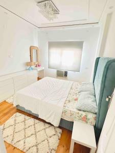 a small bedroom with a bed and a window at Tahrir Retreat in Cairo