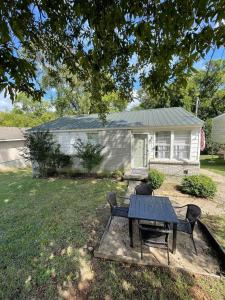a house with a table and chairs in a yard at 47th Place Forest Park in Mountain Brook