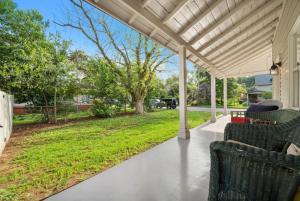 an outdoor patio with chairs and a yard at Bradley Blissful in Chelsea