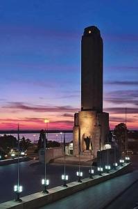 a building with a clock tower at night at Departamento sobre Boulevard Oroño in Rosario