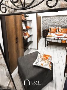 a room with two beds and a shelf at Loft dei Ciclopi Ferentino in Ferentino