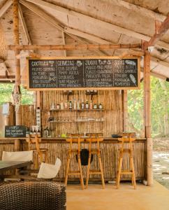 a restaurant with a bar with a sign on it at Santuario Playa Bonita in Buritaca
