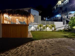 a statue of a woman in a straw hut at night at The Bunkyard Galle Hostel in Galle