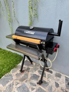 a grill sitting on a table next to a wall at The Bunkyard Galle Hostel in Galle
