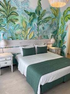 a bedroom with a large bed with a colorful wall at Pousada dos Girassóis in Pipa +68 photos