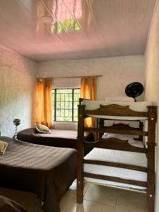 a room with two bunk beds and a window at Finca Turística Las Margaritas in Rivera