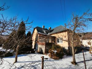 an old house in the snow with a fence at Lipoffka in Lipova Lazne