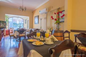 a dining room with a table with food and drinks at Delvino Boutique Hotel in Salta