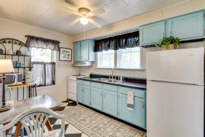 a kitchen with blue cabinets and a white refrigerator at Home Less Than 3 Mi to Rte 66 and Lake Lou Yaeger! in Litchfield